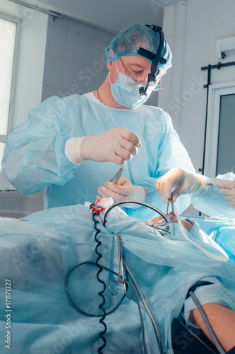 Surgeon operating live shot in surgery room photo