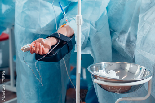 patient lies on the operating surgical table during rhinoplastic operation surgery with anesthesia photo