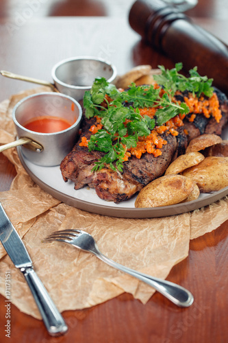 Grilled pork ribs on wooden board, shallow depth of field photo