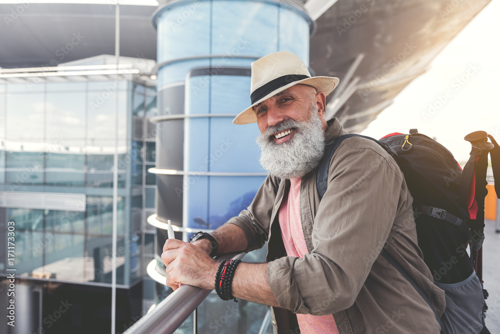 Cheerful smiling mature man ready for trip Cheerful smiling mature man ready for trip