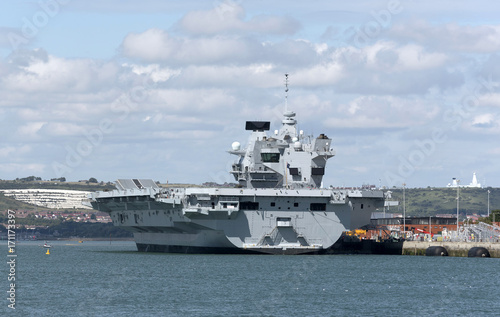 Portsmouth England UK.Royal Navy Dockyard with aircraft carrier HMS Queen Elizabeth alongside the Princess Royal jetty. August 2017.
