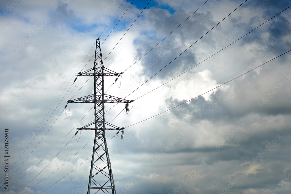 High-voltage line of electricity, in the background the sky is frowning