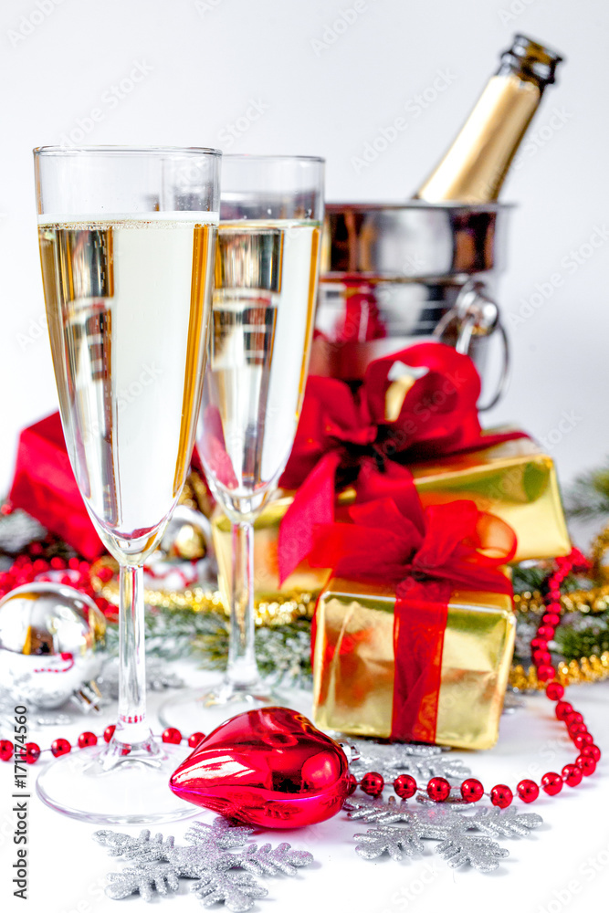glasses of champagne and Christmas ornaments on white background glasses of champagne and Christmas ornaments on white background