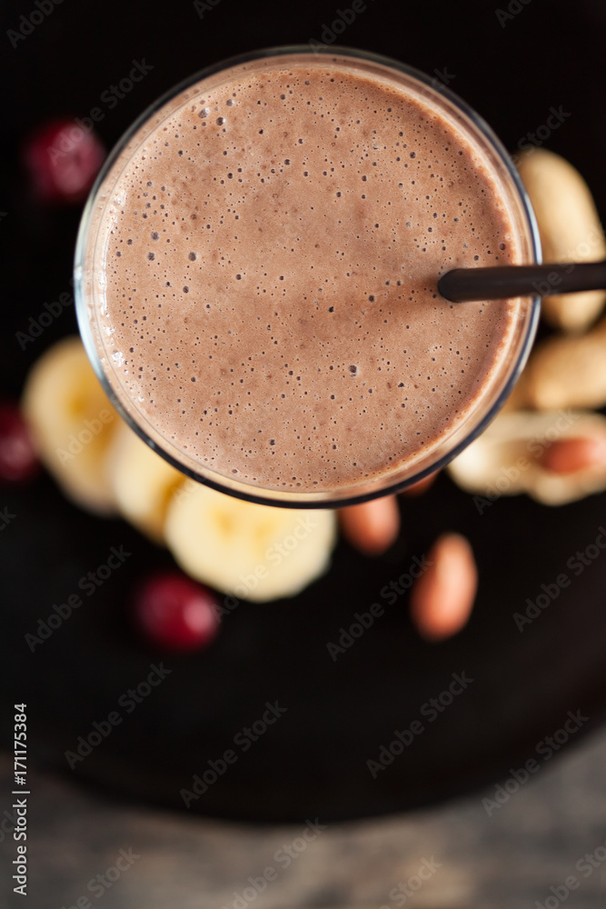 Fresh smoothie with banana, cherry and peanuts - Top view Fresh smoothie with banana, cherry and peanuts - Top view