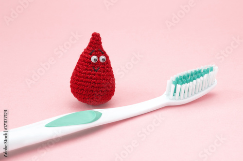 Periodontitis, bleeding gums, hygiene conception photo of periodontal disease. Dental care and toothache. Avoid propblems of teeth and gums. Tooth brush and blood drop.