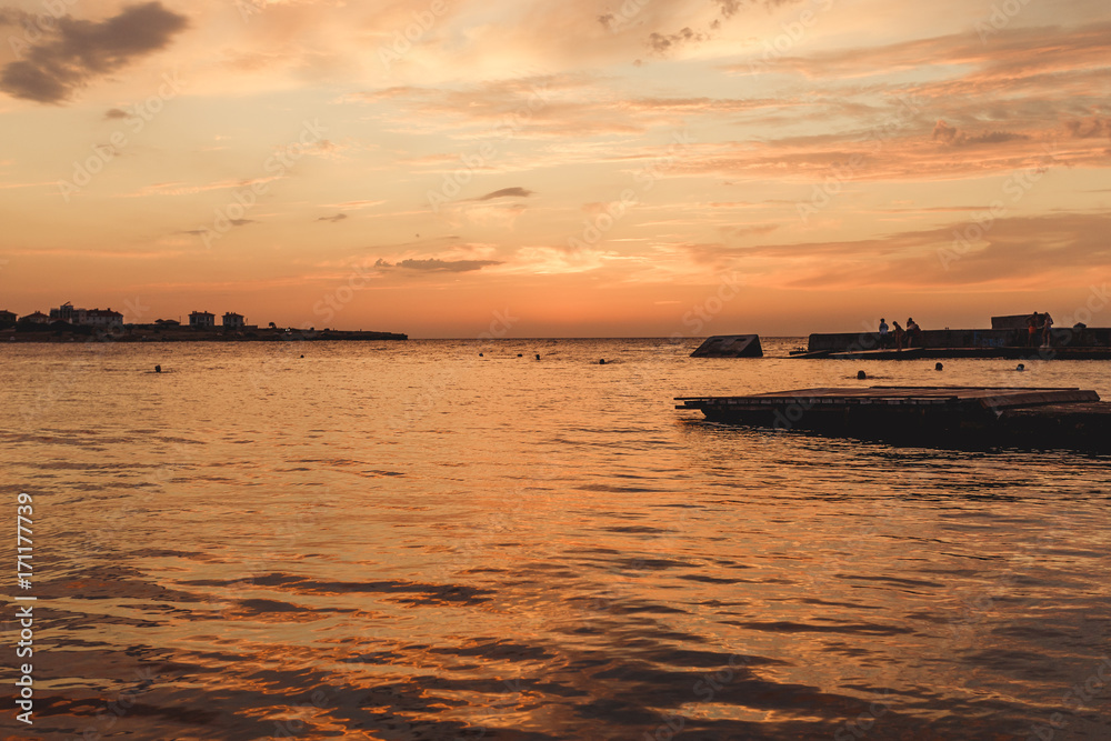 Sunset and the sea. Incredible sky. Whimsical clouds. Patterns in the sky. Evening landscape. Seascape. Background with clouds. After sunset. Pier at sunset. Orange sunset. Sunset and the sea. Incredible sky. Whimsical clouds. Patterns in the sky. Evening landscape. Seascape. Background with clouds. After sunset. Pier at sunset. Orange sunset.