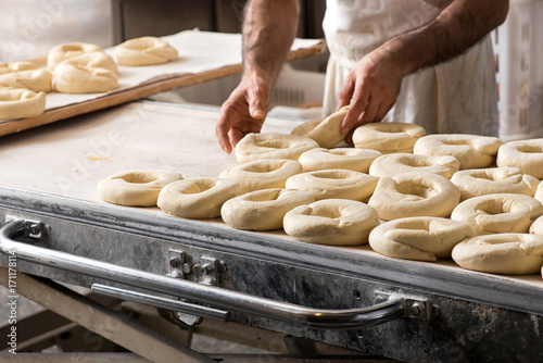 Baker preparing dough for bagels photo