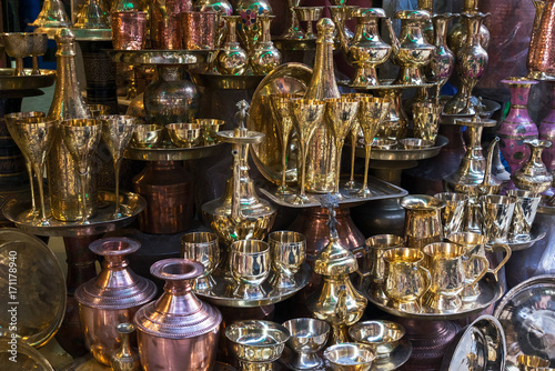 Brass utensils and kitchenware - glasses, jars, trays, cups, bowls, vases on the Thamel market, Kathmandu, Nepal photo