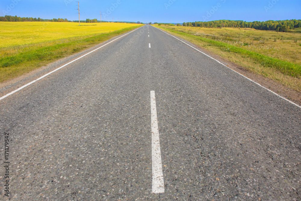 Autumn landscape with highway with field of sky Autumn landscape with highway with field of sky