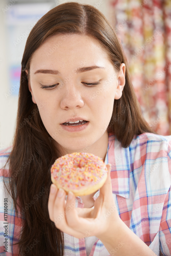 Guilty Looking Teenage Girl On Diet Eating Donut Guilty Looking Teenage Girl On Diet Eating Donut