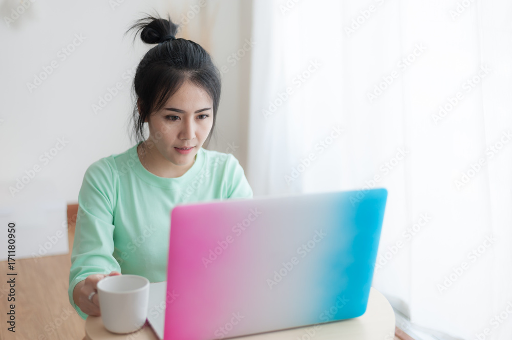 Young Asian woman using laptop computer