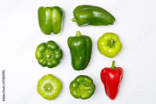 Top view of different kinds of peppers: green pepper, red paprika, on white background. Minimal style. 