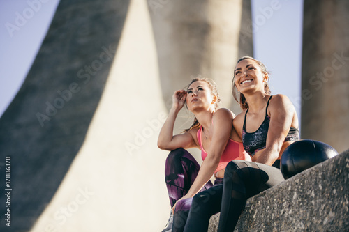 Fitness females relaxing outdoors after workout