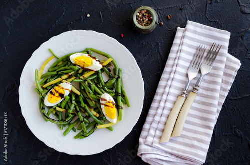 Warm salad with cooked green beans and boiled eggs