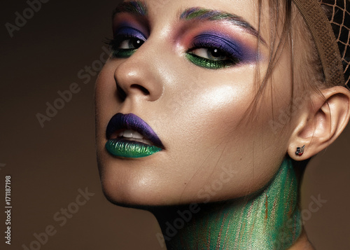 Beautiful girl with creative colorful makeup. Beauty face. Photos shot in studio