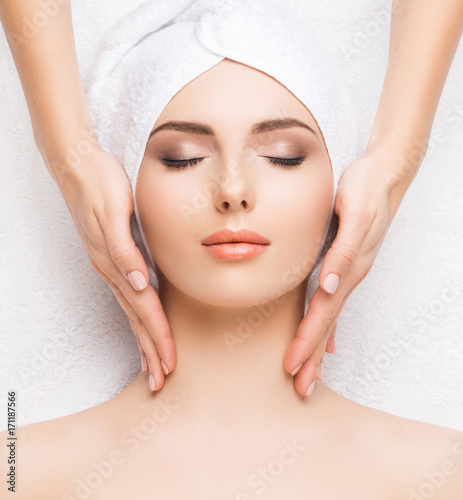 Woman getting face massage treatment. Person in spa. Healthcare, healing, and medicine concept.