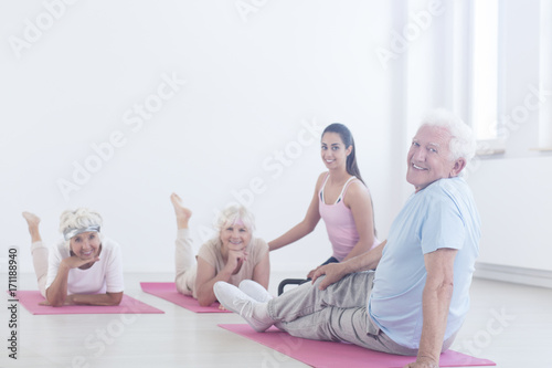 Elderly man relaxing on mat