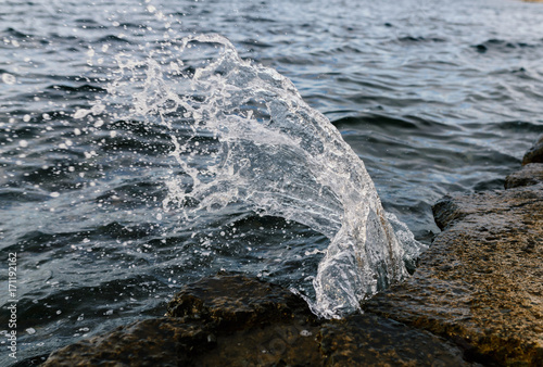 Waves at the seashore. Seafoam. Selective focus with shallow depth of field. photo