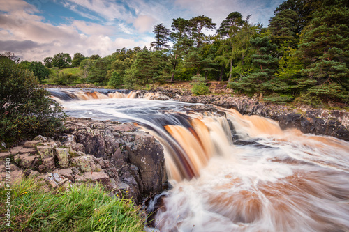 River Tees cascades over Low Force / The River Tees cascades over the Whin Sill at Low Force Waterfall, as the Pennine Way follows the southern riverbank photo