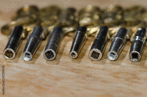 Row of Antique Pocket Watch Keys Laying on the Watchmaker’s Bench