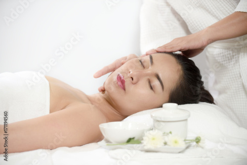 Portrait massage of young beautiful woman getting spa treatment at beauty salon.