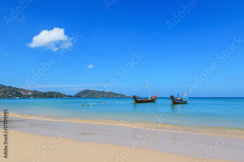 Landscape of long tail boats on Karon and Kata Beaches with blue sky background at Phuket, Thailand.