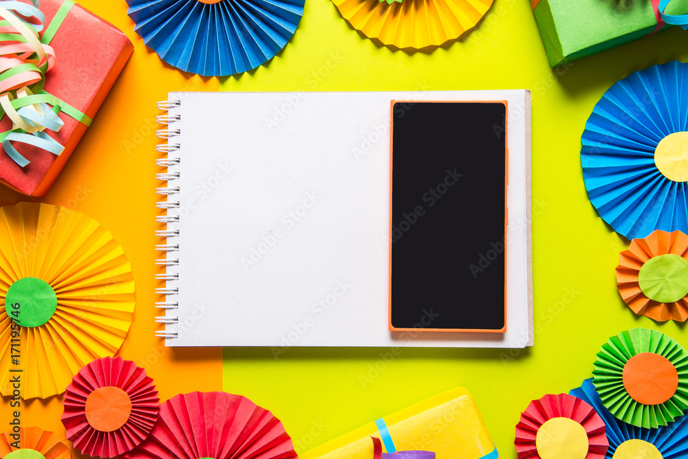 Notebook and smart phone on colorful background