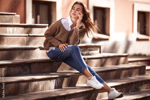 Young and beautiful woman in casual clothes in the street. Autumn fashion concept.