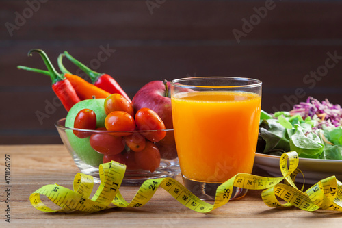 Fresh healthy salad with different fruits and vegetables on wooden background
