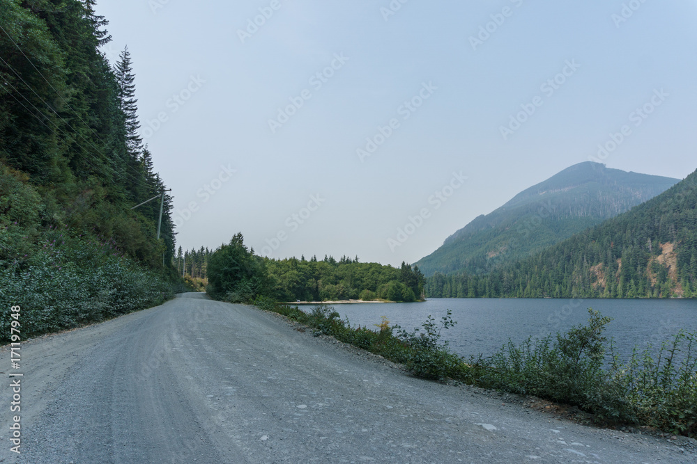 Gravel Road at north in Vancouver island at foggy day.