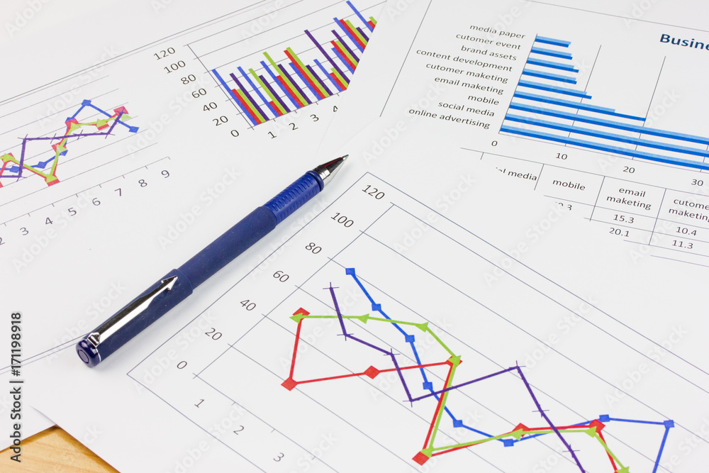 business concept : pen with stock market report as background business concept : pen with stock market report as background