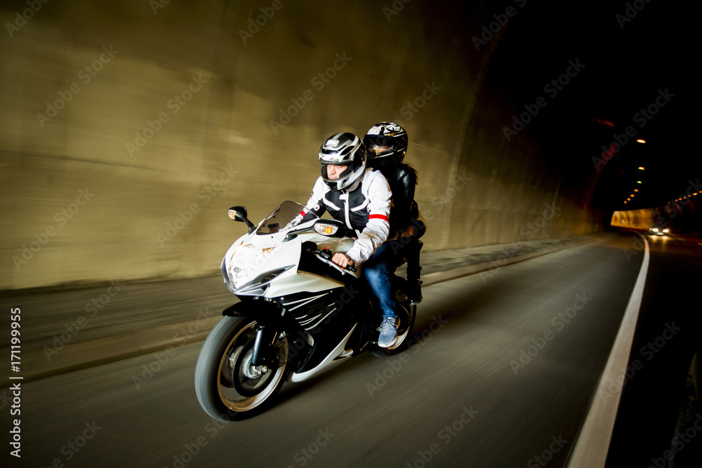 Young man and a woman on a motorcycle