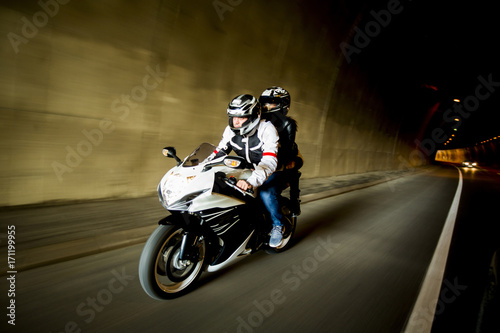 Fototapeta Naklejka Na Ścianę i Meble -  Young man and a woman on a motorcycle