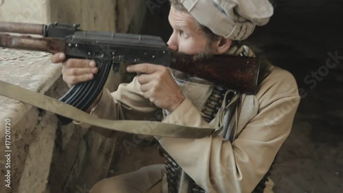 Man with the rifle aiming at the enemy,who is in window