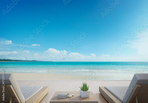 Sea view terrace and beds in modern luxury beach house with blue sky background  Lounge chairs on wooden deck at vacation home or hotel - 3d illustration of tourist resort