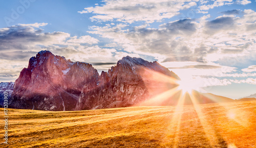 Beautiful autumn mountain scenery in Alps in South Tyrol region of Italian Dolomite Alps. View on mountain ridge. Trentino Alto Adidge, Italy, Alpe di Siusi - Seisser Alm. Fall season scene. photo