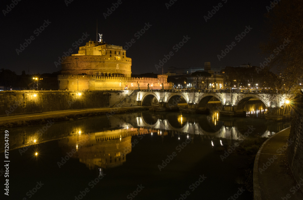 Castel Sant Angelo in Italy Rome at night over Tiber River with reflection
