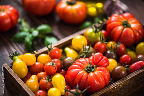 Freshly picked tomatoes in wooden crate