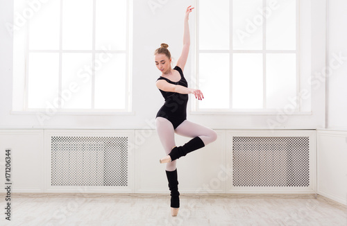 Fototapeta Naklejka Na Ścianę i Meble -  Beautiful ballerina stands in ballet pirouette