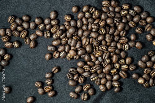 Group of roasted coffee bean on black fabric