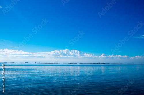 seascape, blue sky and sea with white clouds
