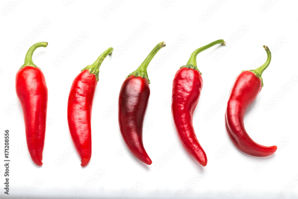 A group of five bitter chili peppers on a white background.