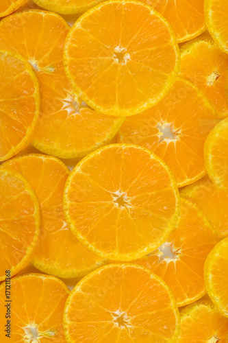 Fresh orange slice stacked several layers, vertical image.