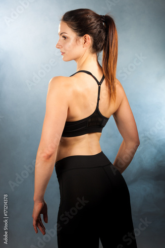 Active young fit woman with perfect body pose