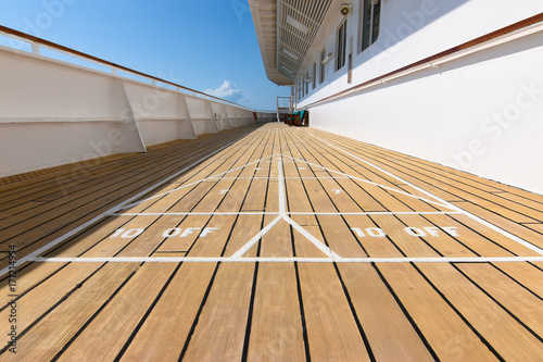 Shuffleboard game on wooden deck of a cruise ship. © Nancy Pauwels