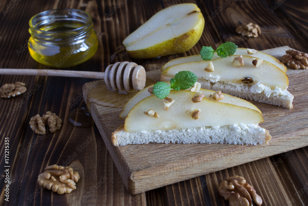 Sandwiches with soft cheese and pear on the wooden background Sandwiches with soft cheese and pear on the wooden background