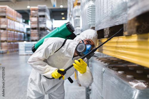 Pest Control Worker Hand Holding Sprayer For Spraying Pesticides in production or manufacturing factory photo