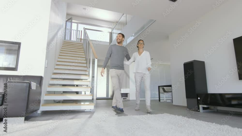 Beautiful Young Couple Enters Their Newly Purchased House, They're Very Happy and Their Home is Bright and Modern. Shot on RED EPIC-W 8K Helium Cinema Camera. Beautiful Young Couple Enters Their Newly Purchased House, They're Very Happy and Their Home is Bright and Modern. Shot on RED EPIC-W 8K Helium Cinema Camera.