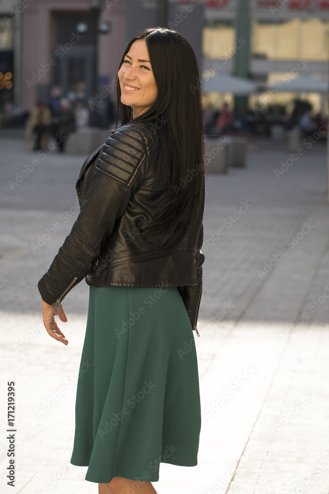 Fototapeta premium Beautiful young brunette girl in a red dress