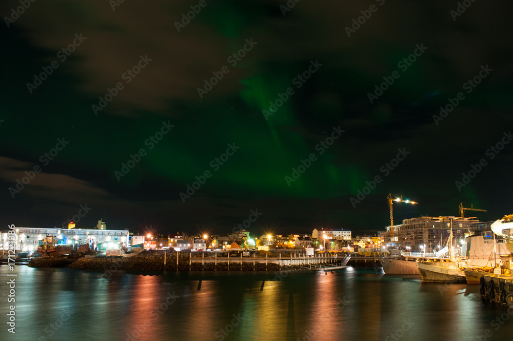 Aurora borealis in Reykjavik harbor in Iceland
